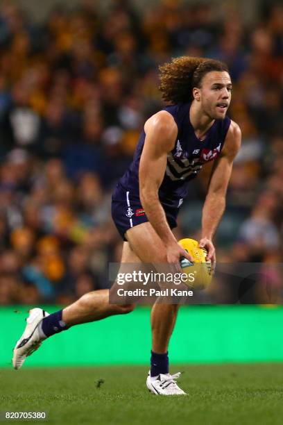 Griffin Logue of the Dockers looks to pass the ball during the round 18 AFL match between the Fremantle Dockers and the Hawthorn Hawks at Domain...