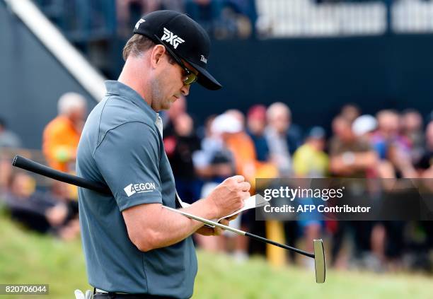Golfer Zach Johnson marks his card on the 7th green during his third round on day three of the Open Golf Championship at Royal Birkdale golf course...