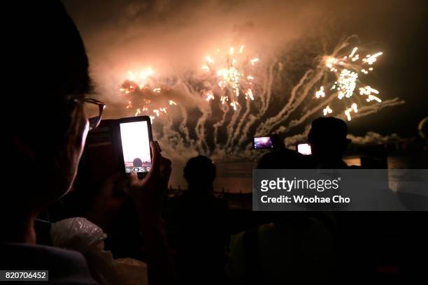 People watch fireworks during the ceremony marking the 200 days to go to the PyeongChang Winter Olympic Games on July 22, 2017 in Chuncheon, South...