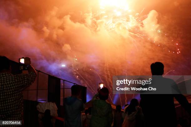 People watch fireworks during the ceremony marking the 200 days to go to the PyeongChang Winter Olympic Games on July 22, 2017 in Chuncheon, South...