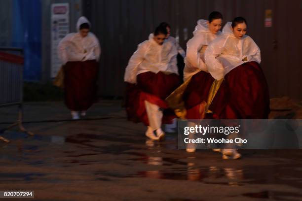 Korean traditional dancers walk to the stage during the ceremony marking the 200 days to go to the PyeongChang Winter Olympic Games on July 22, 2017...