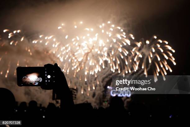 People watch fireworks during the ceremony marking the 200 days to go to the PyeongChang Winter Olympic Games on July 22, 2017 in Chuncheon, South...