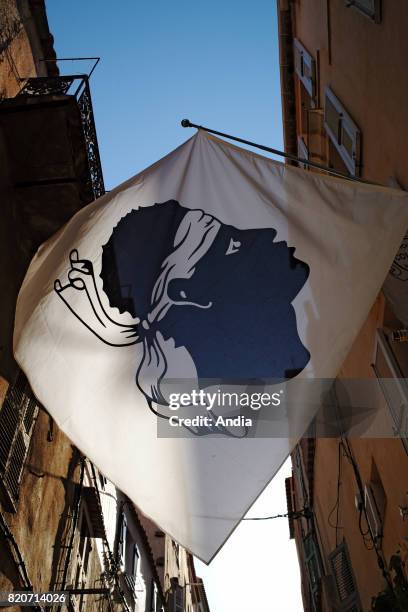 Corsican flag in a street of Bonifacio , blackamoor.