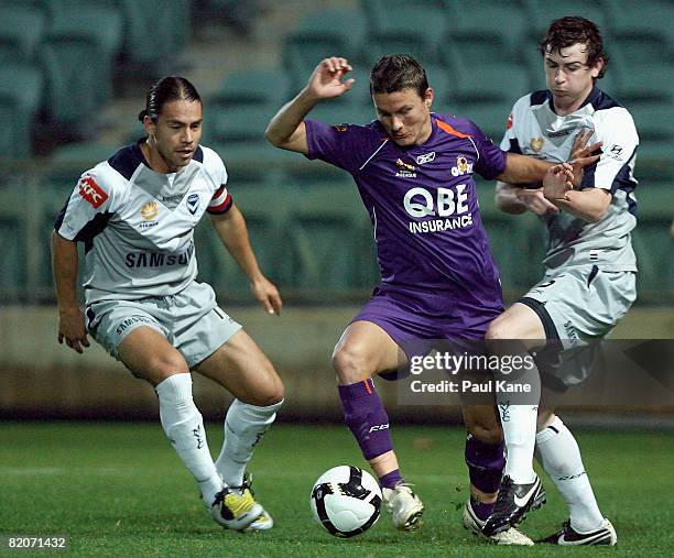 Adrian Trinidad of the Glory is challenged by and Rodrigo Vargas and Sebastian Ryall of the Victory during the A-League Pre-Season Cup match between...