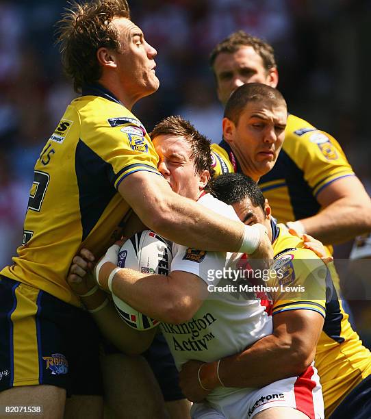 Bryn Hargreaves of St.Helens is tackled by Gareth Ellis of Leeds during the Carnegie Challenge Cup Semi Final match between Leeds Rhinos and...