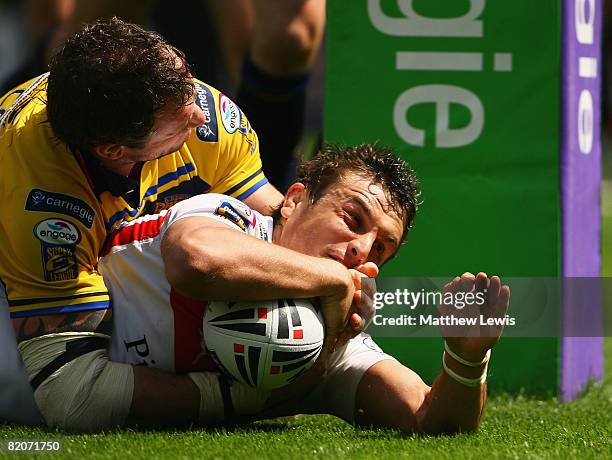 Jon Wilkin of St.Helens beats the tackle from Jamie Peacock of Leeds to score a try during the Carnegie Challenge Cup Semi Final match between Leeds...