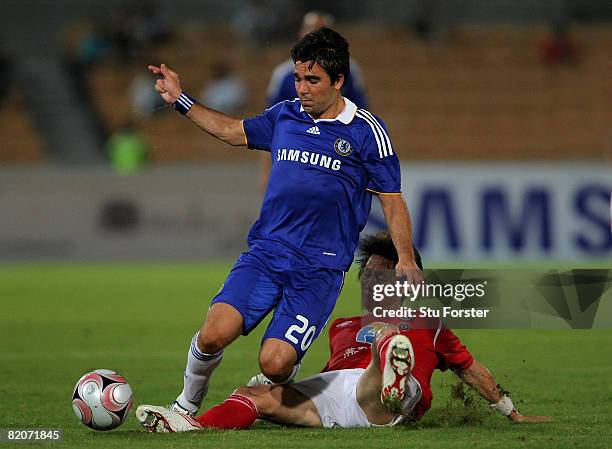 Deco of Chelsea is challenged by Blades captain Li Tie during the Macau International Football challenge between Chelsea and Chengdu Blades FC at...