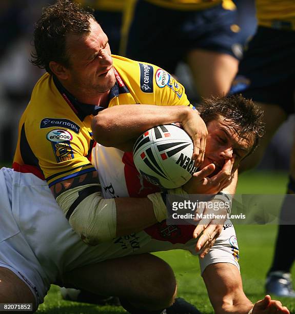 Jamie Peacock of Leeds tries to stop Jon Wilkin of St.Helens from scoring a try during the Carnegie Challenge Cup Semi Final match between Leeds...