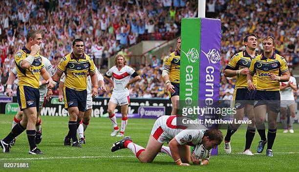 Bryn Hargreaves of St. Helens scores a try as the Leeds Rhinos look on during the Carnegie Challenge Cup Semi Final match between Leeds Rhinos and...