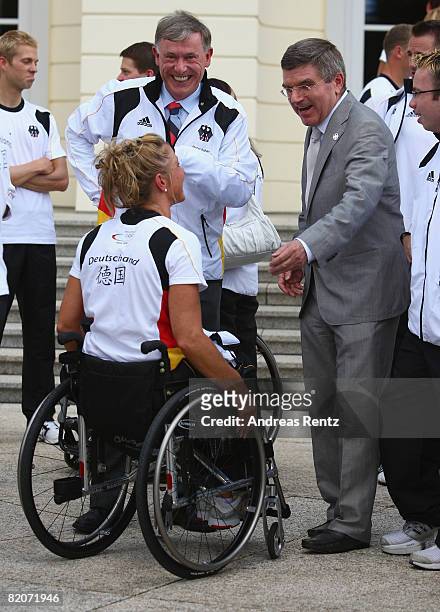 German President Horst Koehler and Thomas Bach , president of the German Olympic Sports Association DOSB, chat with a athlete of the German Olympic...