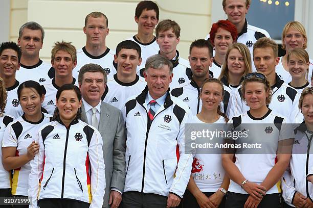 Thomas Bach , president of the German Olympic Sports Association DOSB, and German President Horst Koehler pose with athletes of the German Olympic...