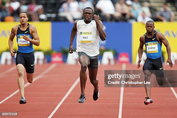 Usain Bolt of Jamaica competes on the way to winning first place in the Men's 200 Metres Final alongside Wallace Spearmon of United States and Rodney...