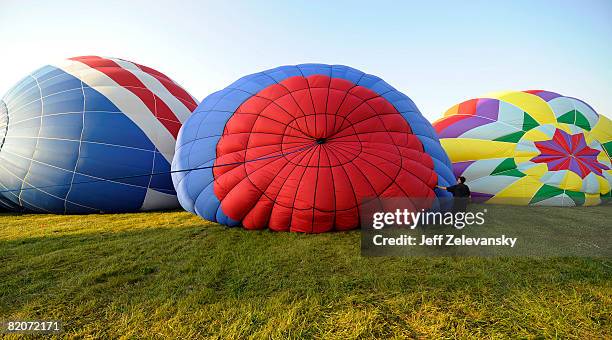 Wrangler works to inflate a hot air balloon at the 26th Annual Quick Chek New Jersey Festival of Ballooning at the Solberg Airport July 26, 2008 in...