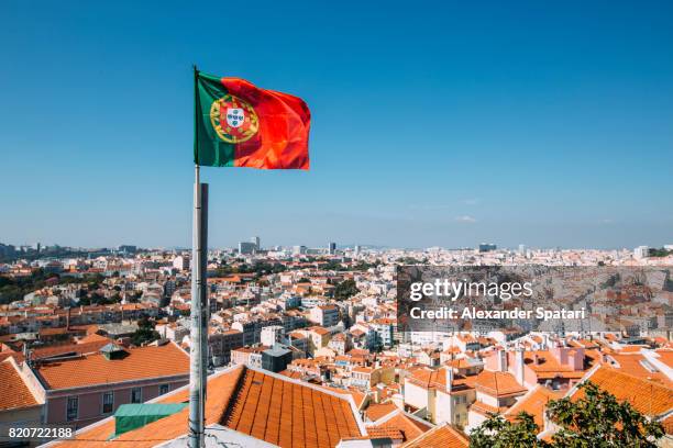portuguese flag and lisbon skyline, portugal - flag of lisbon photos et images de collection