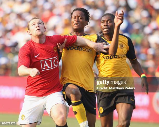 Wayne Rooney of Manchester United clashes with Renielwe Letsholonyane of Kaizer Chiefs during the Vodacom Challenge pre-season friendly match between...