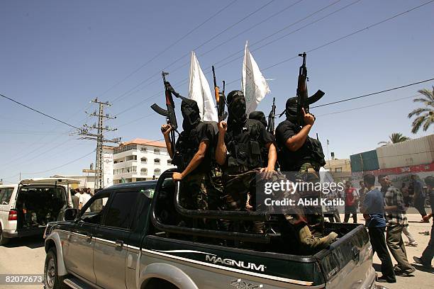 Masked Palestinian gunmen attend the funeral of six bomb victims on July 26, 2008 in Gaza City, Gaza Strip. Police loyal to ruling political party...