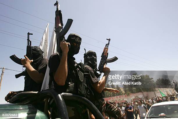 Masked Palestinian gunmen attend the funeral of six bomb victims on July 26, 2008 in Gaza City, Gaza Strip. Police loyal to ruling political party...