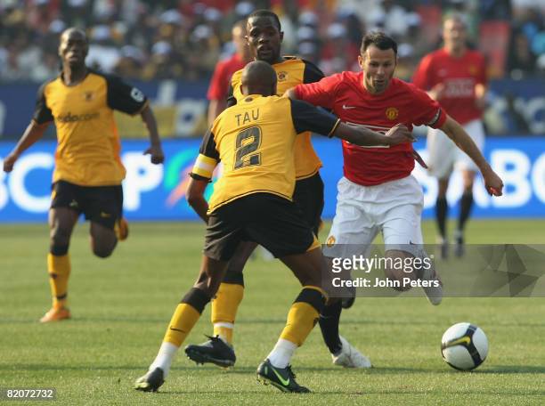 Ryan Giggs of Manchester United clashes with Jimmy Tau of Kaizer Chiefs during the Vodacom Challenge pre-season friendly match between Kaizer Chiefs...