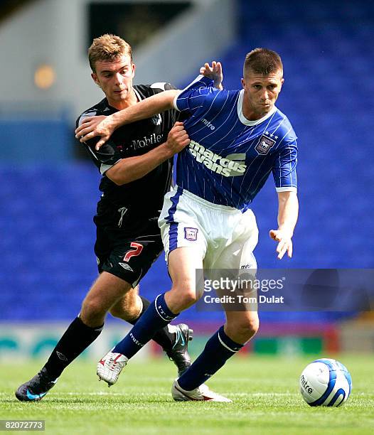 James Morrison of West Bromwich Albion battles for the ball with Veliche Shumulikoski of Ipswich Town during the Pre Season Friendly match between...