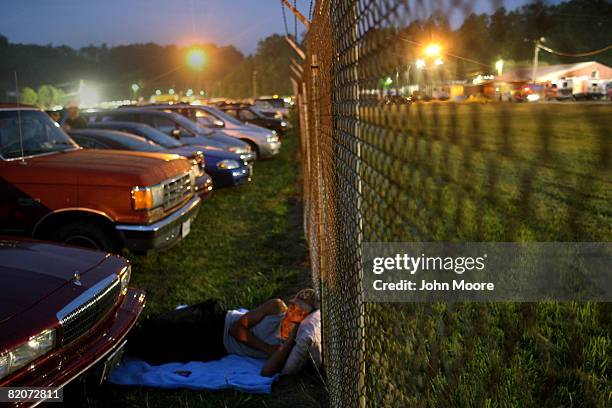 Adrian Courtney, from Coburn, Virginia, wakes from a night of sleeping outside the Remote Area Medical , clinic July 26, 2008 in Wise, Virginia. The...