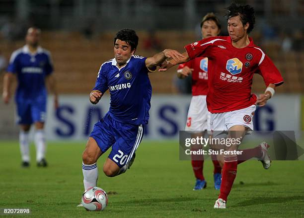 Deco of Chelsea is challenged by Blades captain Li Tie during the Macau International Football challenge between Chelsea and Chengdu Blades FC at...