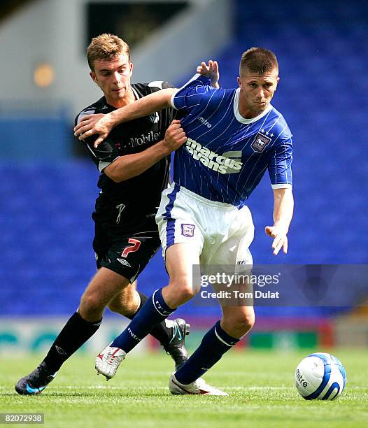 James Morrison of West Bromwich Albion battles for the ball with Veliche Shumulikoski of Ipswich Town during the Pre Season Friendly match between...