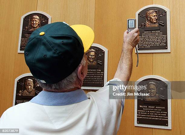 The plaque of Honus Wagner is photographed by a fan at the National Baseball Hall of Fame and Museum during the Baseball Hall of Fame weekend on July...