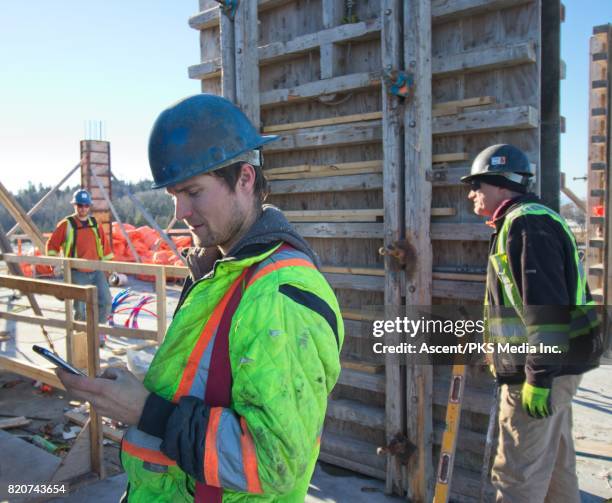 construction workers at work on outdoor construction site - dirty construction worker stock pictures, royalty-free photos & images