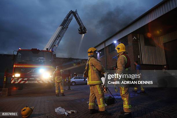 Firefighters from Surrey fire brigade tackle a fire at M.Y. Healthcare, a pharmaceutical packaging company near Egham, some 25 miles west of London...