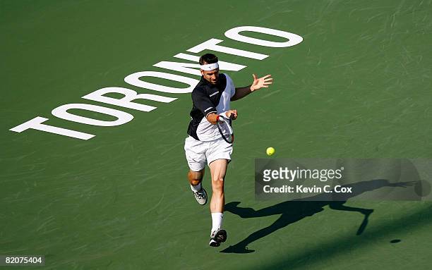 Nicolas Kiefer of Germany returns a shot to Gilles Simon of France during the Rogers Cup at the Rexall Centre at York University on July 26, 2008 in...