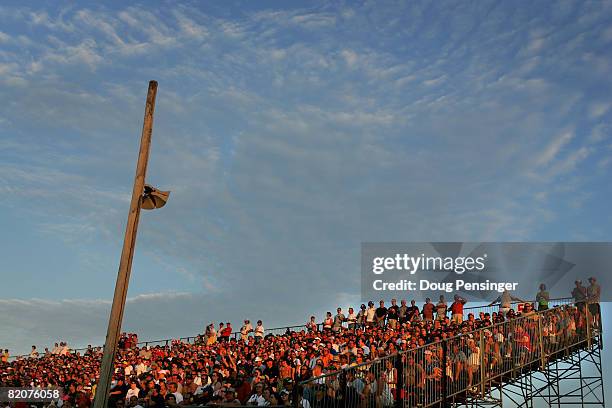 Fans basque in the sunset as they watch the NASCAR Nationwide Series Kroger 200 on July 26, 2008 at O'Reilly Raceway Park in Indianapolis, Indiana.