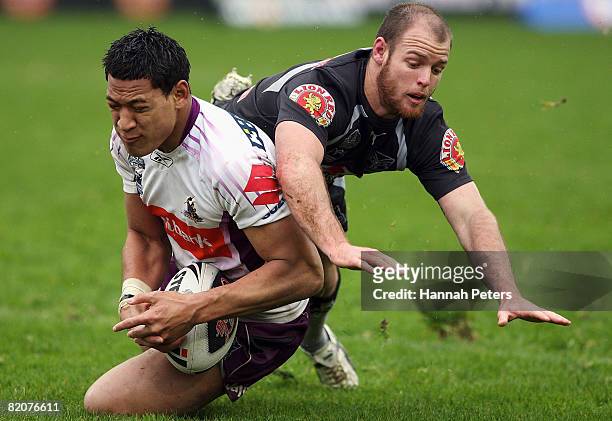 Israel Folau of the Storm competes with Grant Rovelli of the Warriors for the ball during the round 20 NRL match between the New Zealand Warriors and...