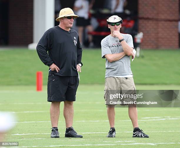 Head Coach Mike Smith and General Manager Thomas Dimitroff of the Atlanta Falcons watch play during training camp at the Atlanta Flacons Training...