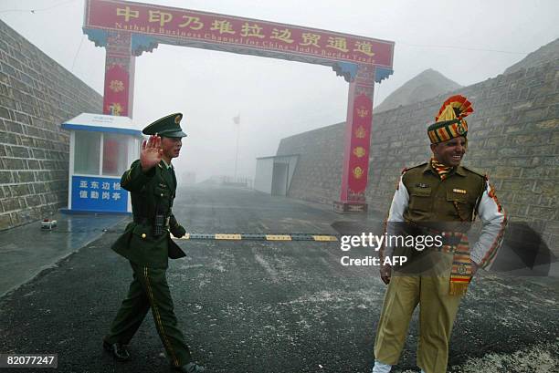 In this photograph taken on July 10, 2008 a Chinese soldier and an Indian soldier stand guard at the Chinese side of the ancient Nathu La border...