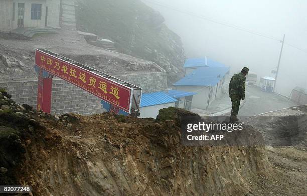 In this photograph taken on July 10, 2008 a Chinese soldier stands guard on the Chinese side of the ancient Nathu La border crossing between India...