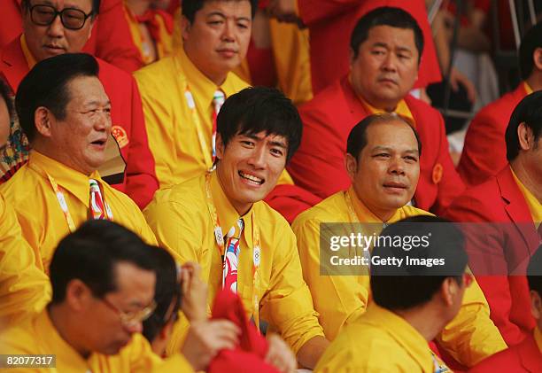 China's Olympic champion hurdler Liu Xiang reacts as he chats with Chinese Olympic team delegates during the opening ceremony of the Olympic Village...