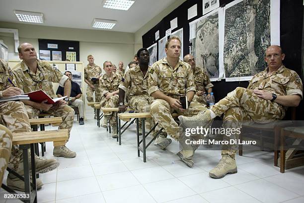 British Army soldiers and officers from the 5th Battalion Royal Regiment of Scotland attend a daily briefing in the regiment operation room at...
