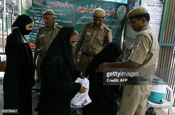 Indian police check the bags of Indian Muslim women visiting the Jama Masjid mosque in New Delhi on July 27 after security was put on high alert...