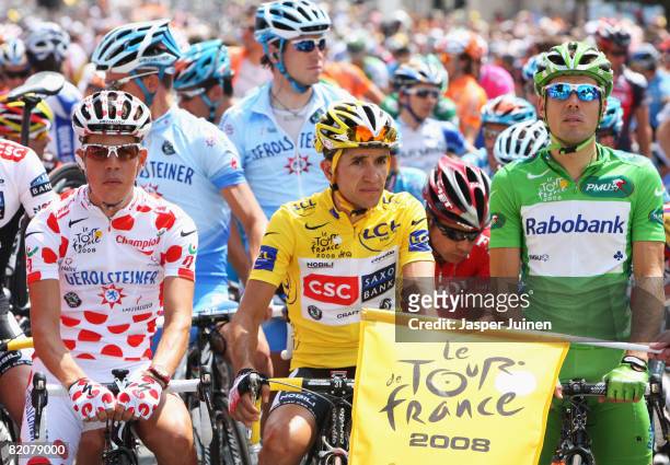 Polka Dot King of the Mountains Jersey winner Bernhard Kohl of Austria and Gerolsteiner, Yellow Jersey overall race winner Carlos Sastre of Spain and...