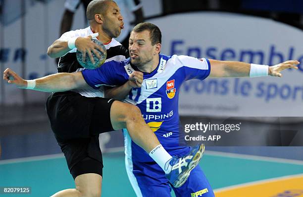 Egypt's Hassan Yosri vies with Iceland's Sverre Jakobsson during their Euro Tournament handball match on July 27, 2008 in Strasbourg, eastern France....