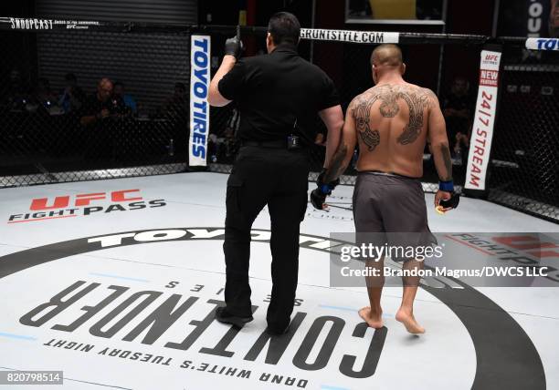 Referee John McCarthy takes away one point from Angel De Anda for illegal hits to the back of Daniel Spohn's head in their light heavyweight bout...