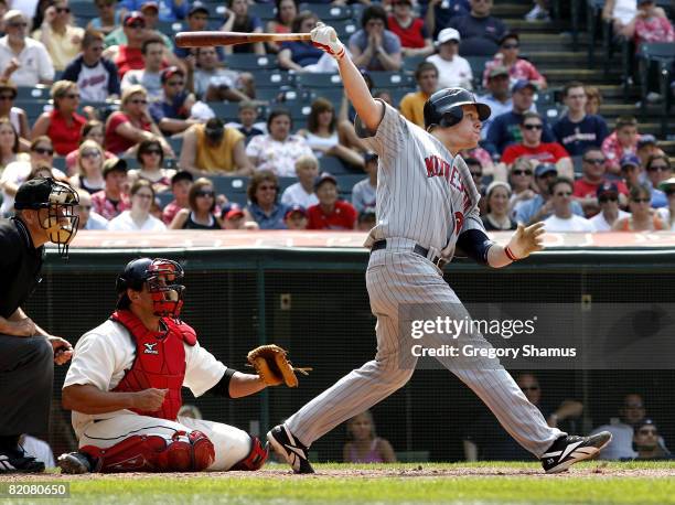 Justin Morneau of the Minnesota Twins hits a double in the ninth inning to score Alexi Casilla for the go ahead run in front of Sal Fasano of the...