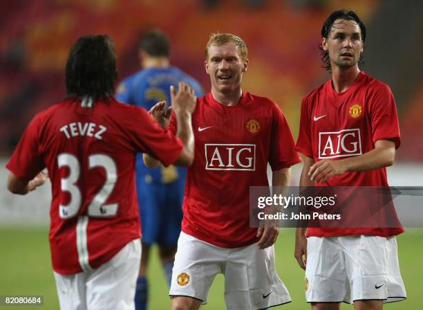 Carlos Tevez of Manchester United celebrates scoring their second goal with Paul Scholes and Chris Eagles during the pre-season friendly match...