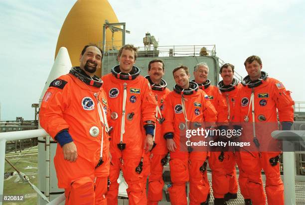 The STS-100 crew poses for a photo on the 195-foot level of Launch Pad 39A's Fixed Service Structure March 30, 2001 at the Kennedy Space Center in...