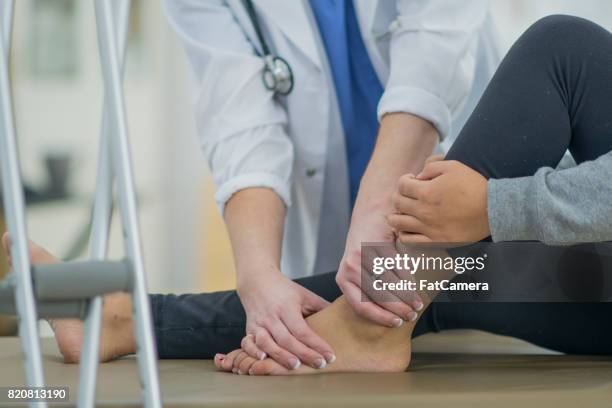 checking ankle - ankle stock pictures, royalty-free photos & images