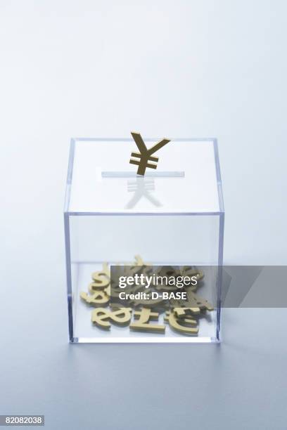 golden currency into the glass coin bank - rupee symbol stock pictures, royalty-free photos & images