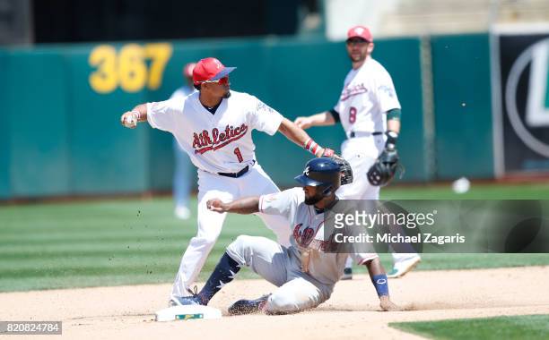 Franklin Barreto of the Oakland Athletics forces Danny Santana of the Atlanta Braves out at second during the game at the Oakland Alameda Coliseum on...
