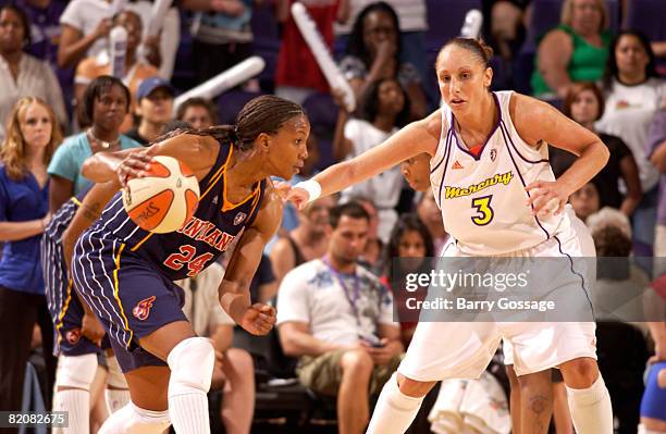 Tamika Catchings of the Indiana Fever dribbles against Diana Taurasi of the Phoenix Mercury on July 27 at U.S. Airways Center in Phoenix, Arizona....
