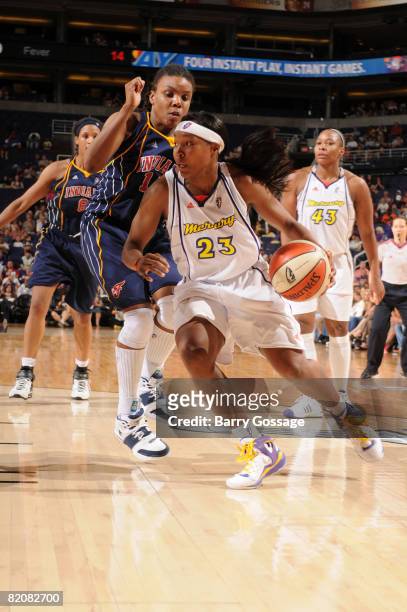 Cappie Pondexter of the Phoenix Mercury drives against Tan White of the Indiana Fever on July 27 at U.S. Airways Center in Phoenix, Arizona. NOTE TO...