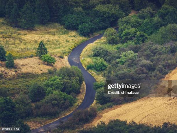 winding highway between wheat fields,aerial view - palouse stock pictures, royalty-free photos & images